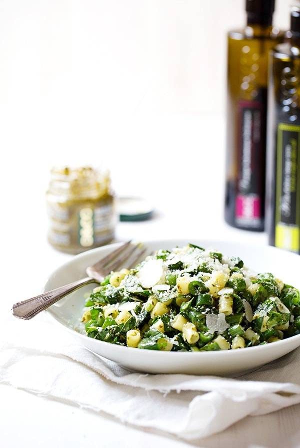 Pasta salad on a white plate with a fork.