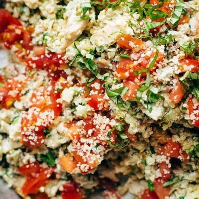 Healthy Chicken Salad in a serving bowl with wooden spoon.