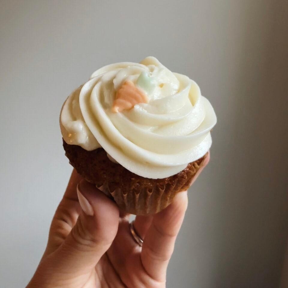 Carrot cake cupcake with carrot frosting decoration.
