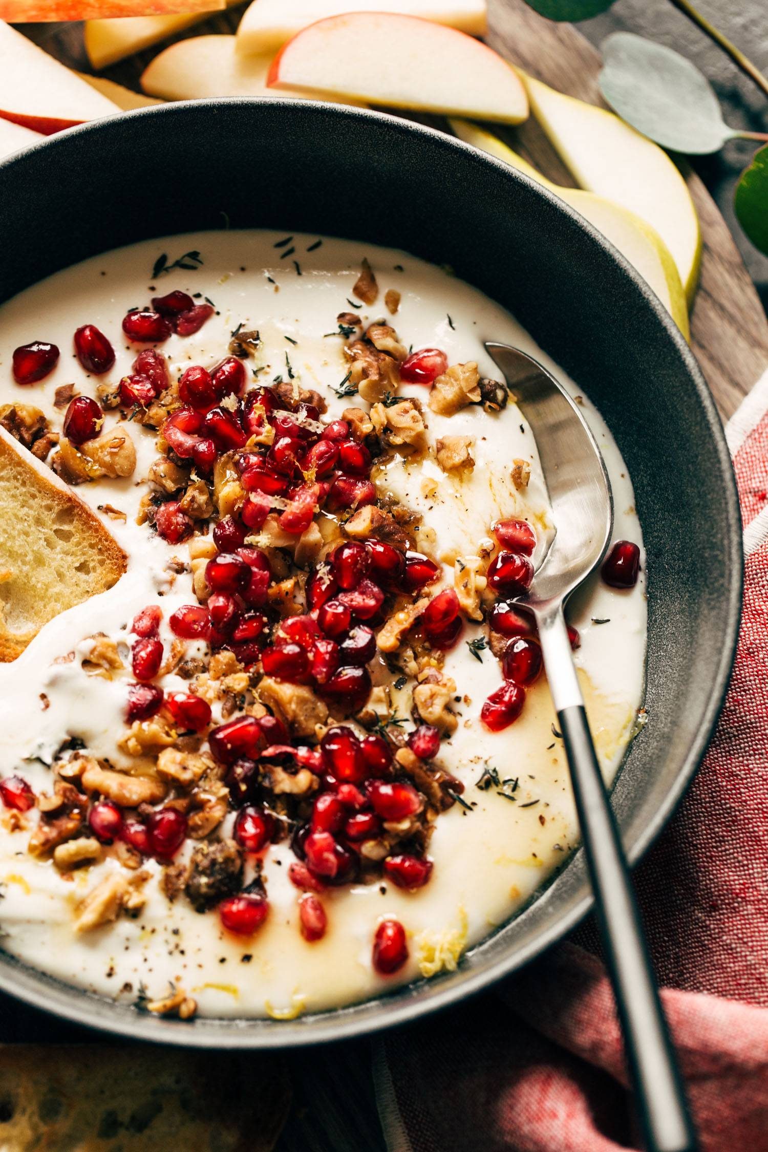 Whipped feta in a bowl with pomegranate on top.