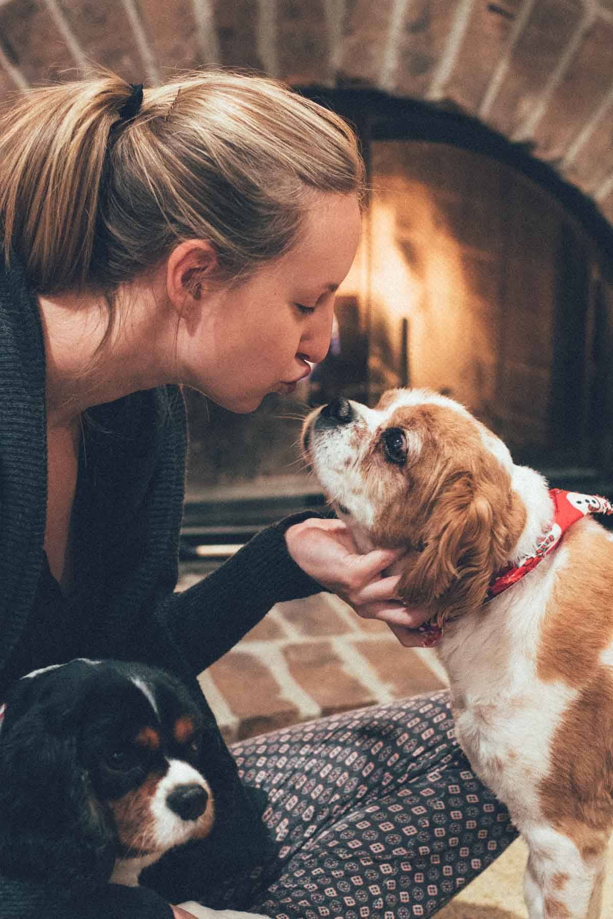 Woman kissing a dog.