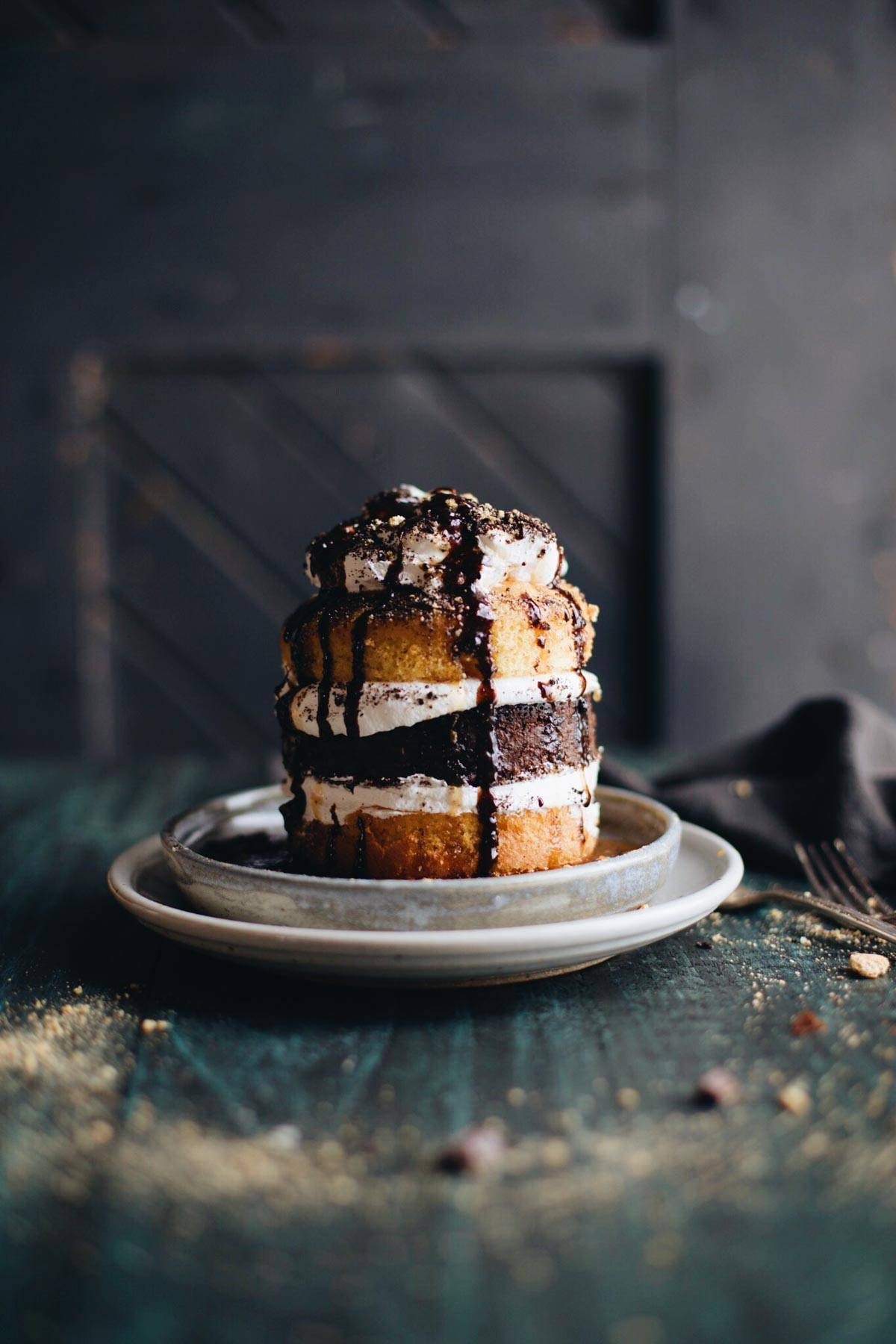 Small cake on a plate with a a dark background.