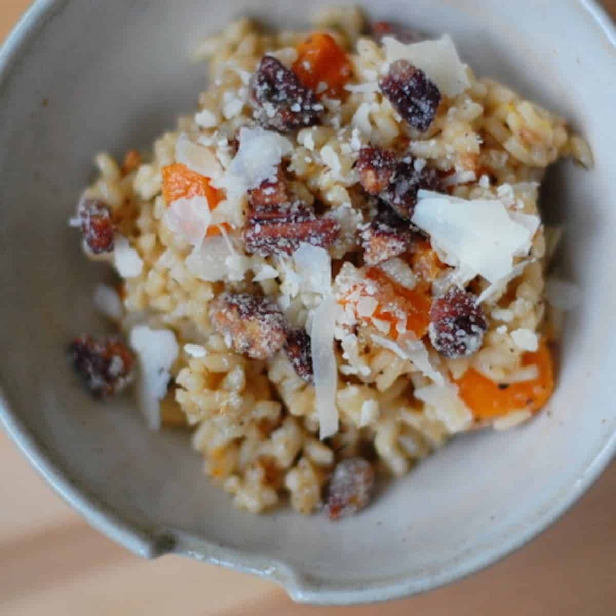 Creamy butternut squash risotto in a grey bowl.